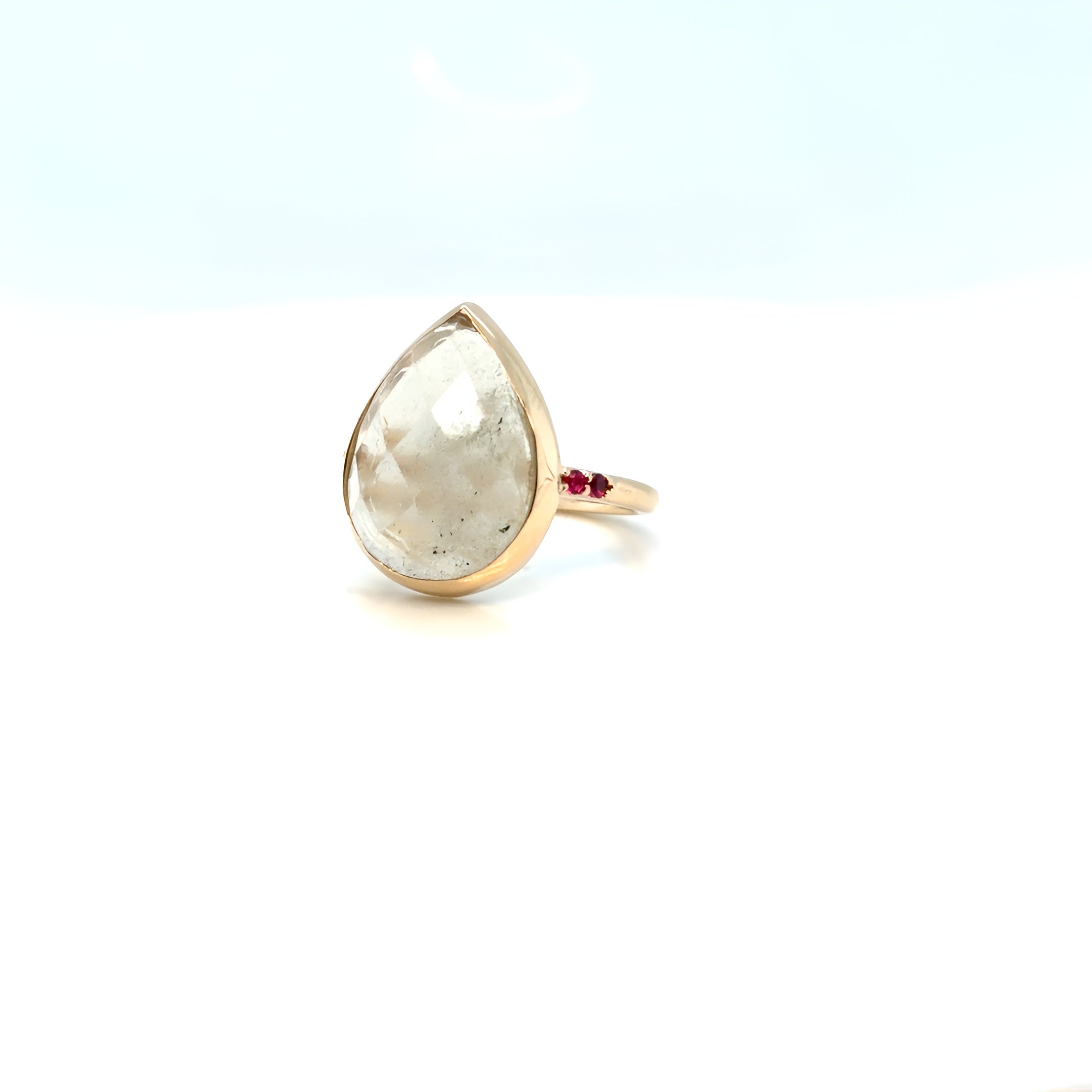 Rose-cut pear stone in a full 14K yellow gold bezel, with natural rubies flush-set into the shank — custom design by Farsi Jewelers, Sandy Springs GA
