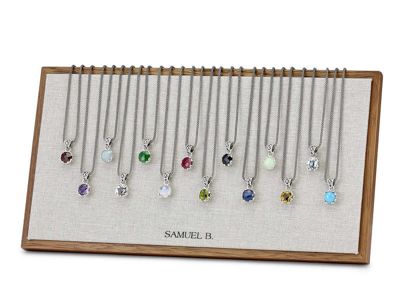 A full set of Samuel B. birthstone pendant necklaces, one for every month, displayed together at Farsi Jewelers