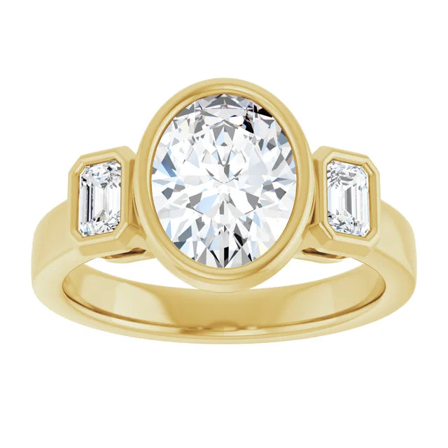 Face-up view of the 14K yellow gold three-stone ring, the oval center diamond in a full bezel with a bezel-set emerald-cut diamond on each side