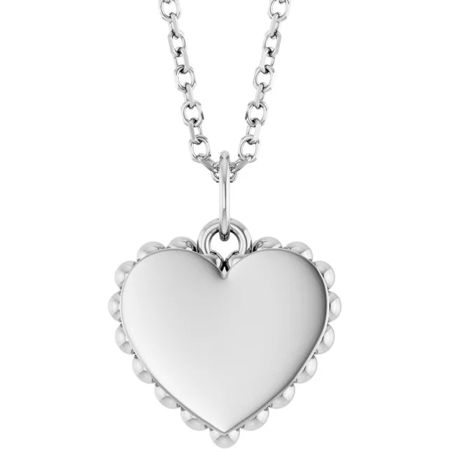 Sterling silver heart pendant with a beaded edge and a smooth polished face, on a cable chain