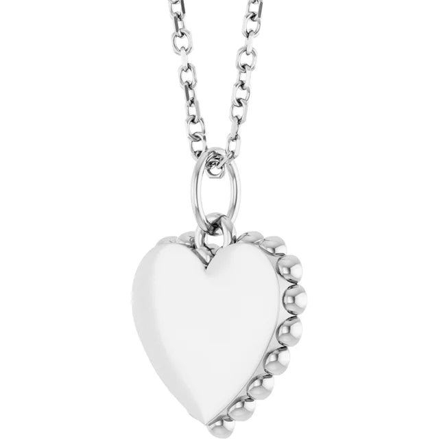Sterling silver engravable heart pendant, angled view showing the beaded border around the edge