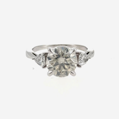 Load image 1 in gallery view. 14K white gold three-stone engagement ring with two trillion lab-grown diamonds, front view, shown with a round center stone that is not included
