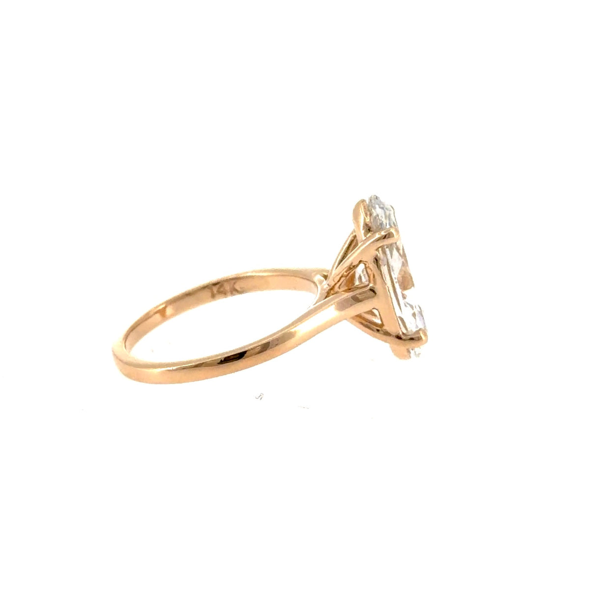 Side view of the 14K yellow gold cathedral solitaire showing the raised four-prong setting and the 14K stamp inside the shank
