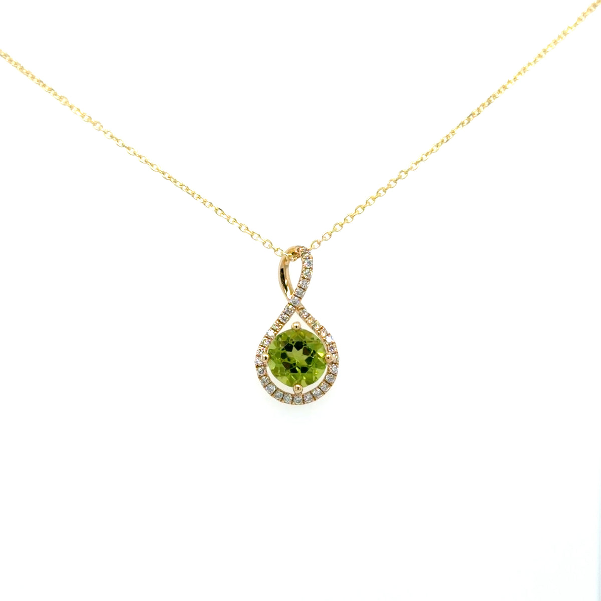 14K yellow gold peridot pendant on a gold chain — round green peridot held inside a diamond-lined teardrop frame that twists over itself into the bail, by Farsi Jewelers Sandy Springs