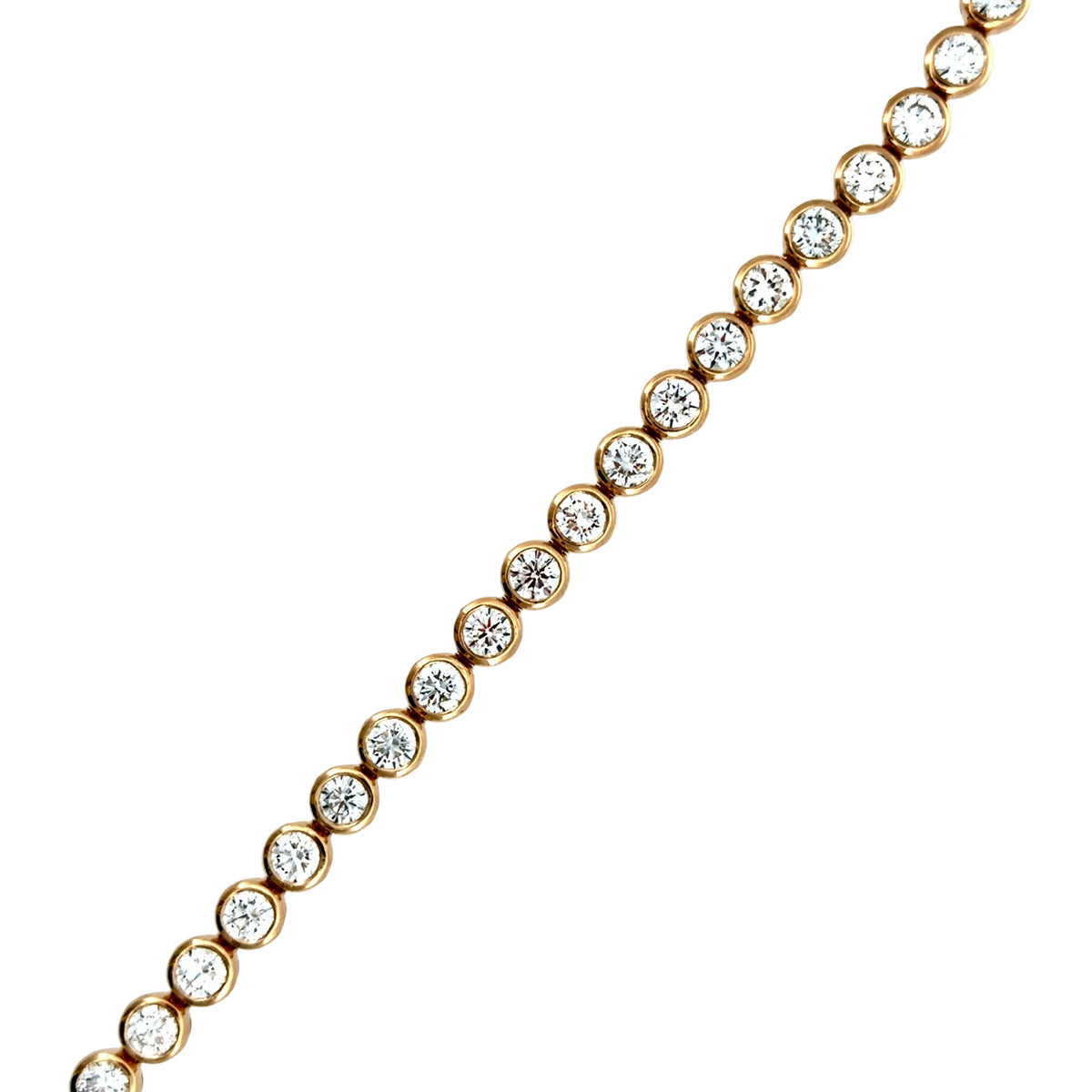Close-up of the bezel-set lab-grown diamonds in 14K yellow gold, showing the smooth rim of gold around each stone