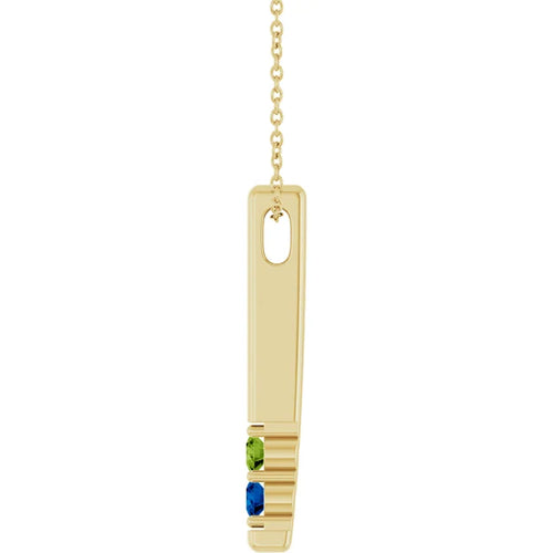 Load image 1 in gallery view. Side view of the yellow gold bar necklace showing the chain loop and the peridot and lab-grown sapphire