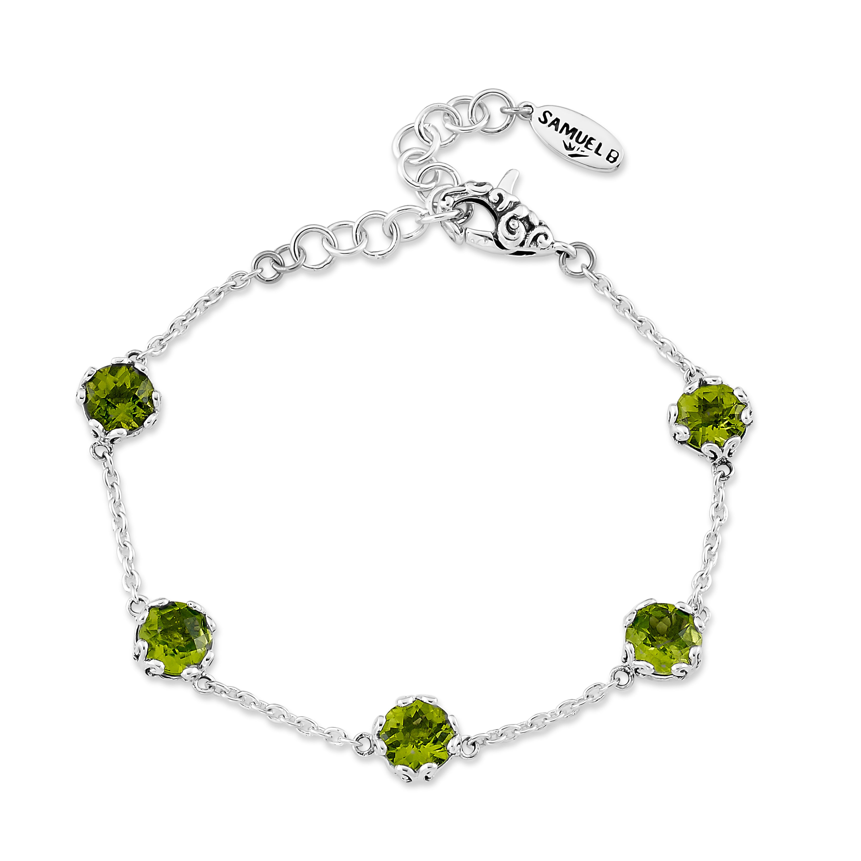 Silver bracelet with green gemstones on a white background