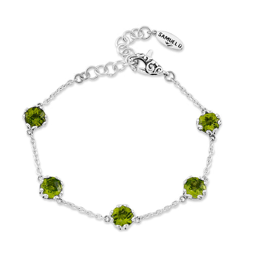 Load image 1 in gallery view. Silver bracelet with green gemstones on a white background