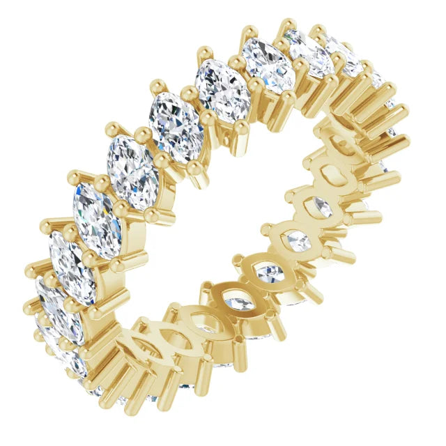 Gold ring with clear gemstones on a white background