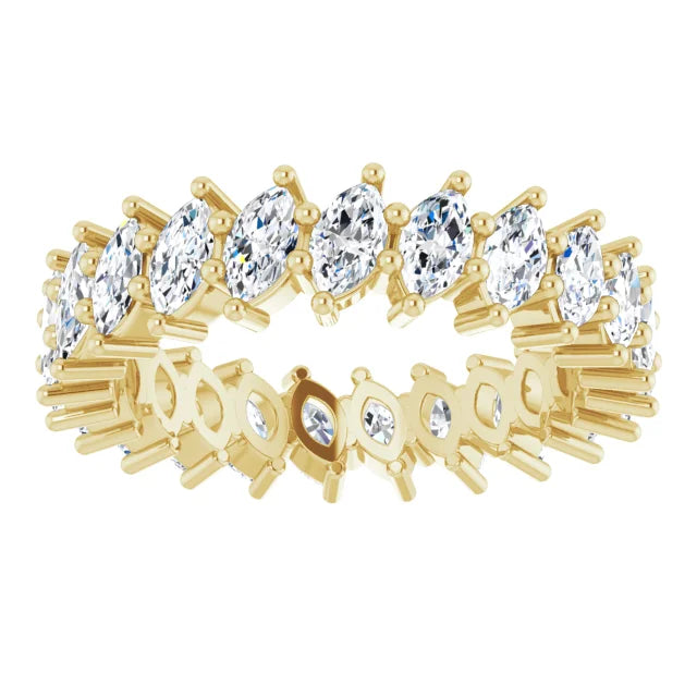 Gold ring with clear gemstones on a white background