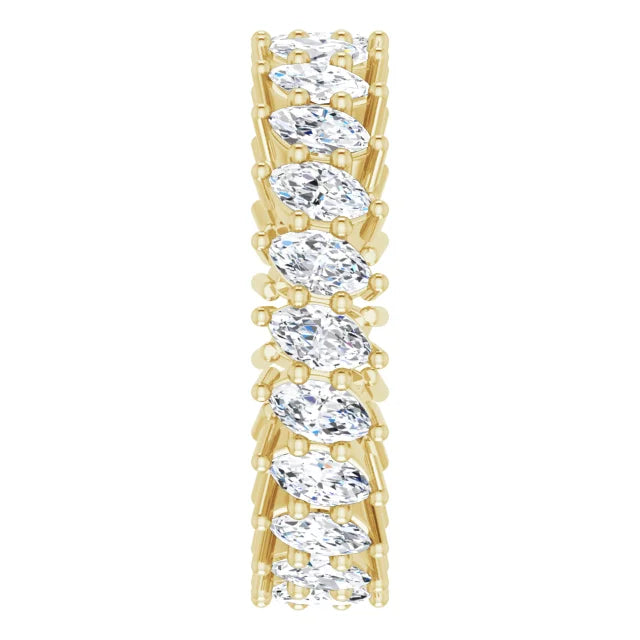Gold ring with marquise-shaped diamonds on a white background