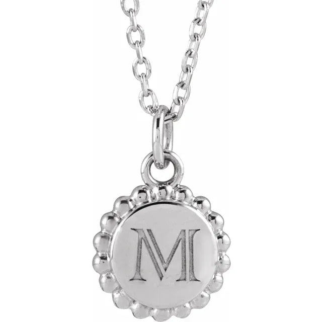 Example of engraving: the sterling silver beaded disc pendant shown with an initial engraved on the face