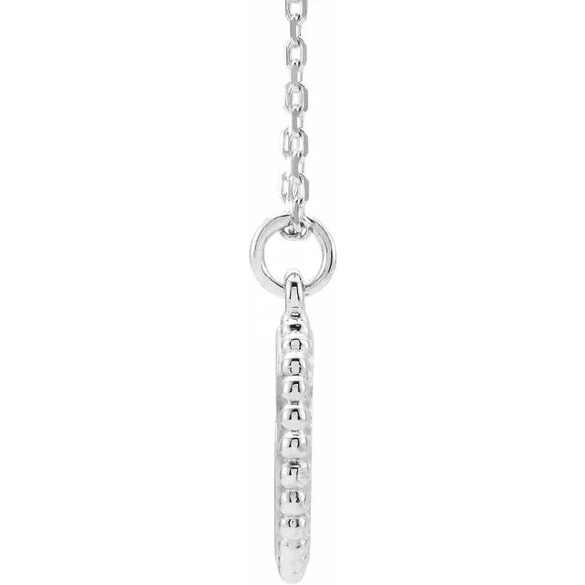 Side profile of the sterling silver beaded disc pendant, showing the beaded edge and the bail