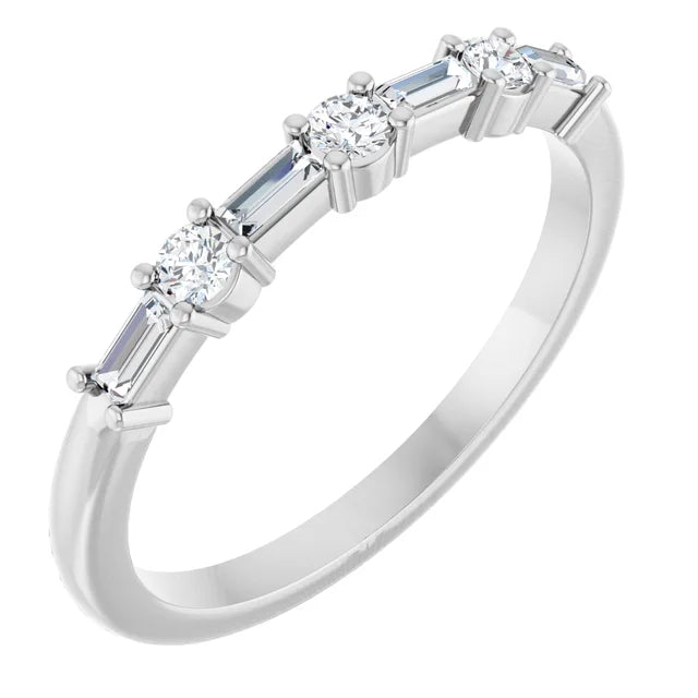 Angled view of a slim 14K white gold wedding band with alternating round and tapered baguette lab-grown diamonds prong-set across the top