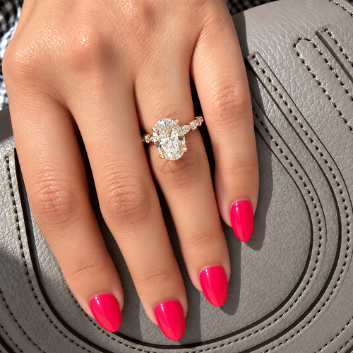 Load image 1 in gallery view. 3 carat oval lab-grown diamond engagement ring with marquise side stones in 14K yellow gold, worn on the hand