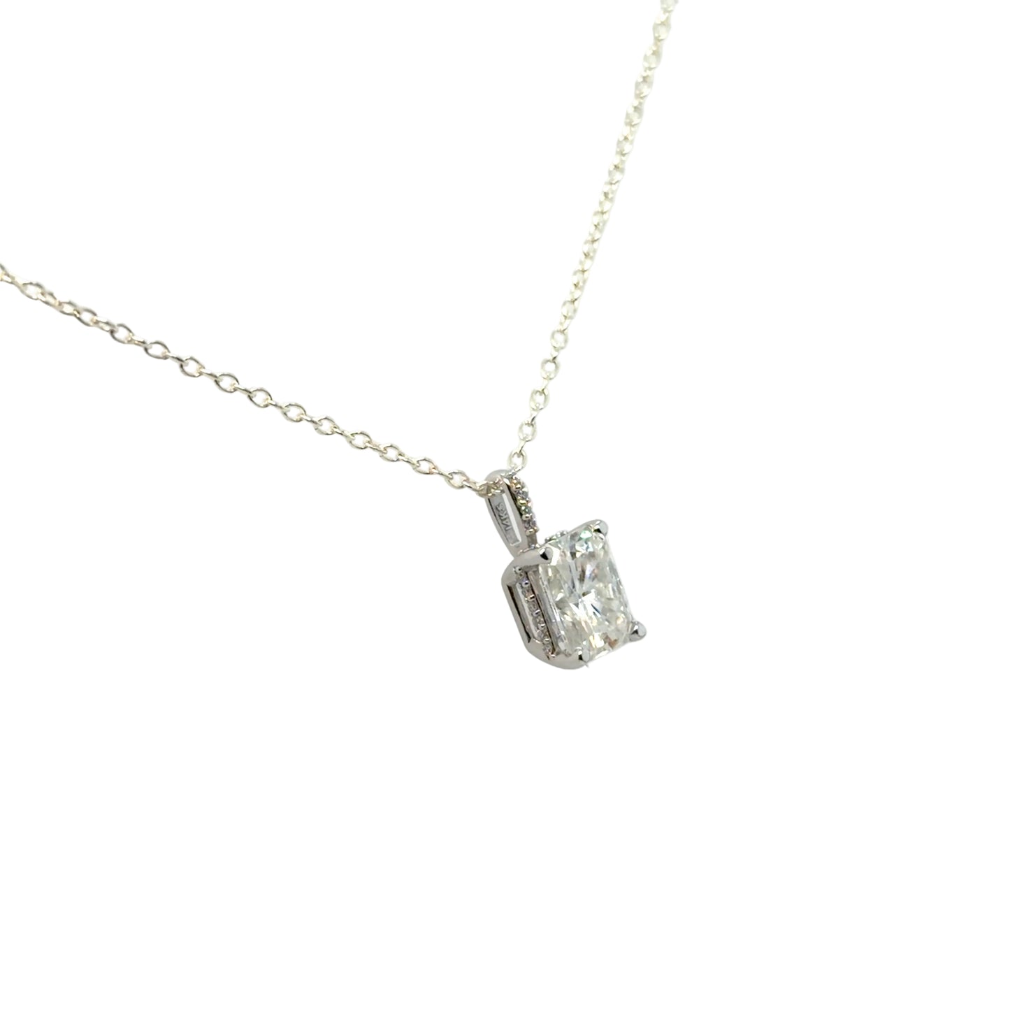 14K white gold solitaire pendant mounting shown at an angle, holding a radiant-cut moissanite in four prongs, with small accent diamonds set along the bail. Shown on a display chain; chain and center stone are not included.