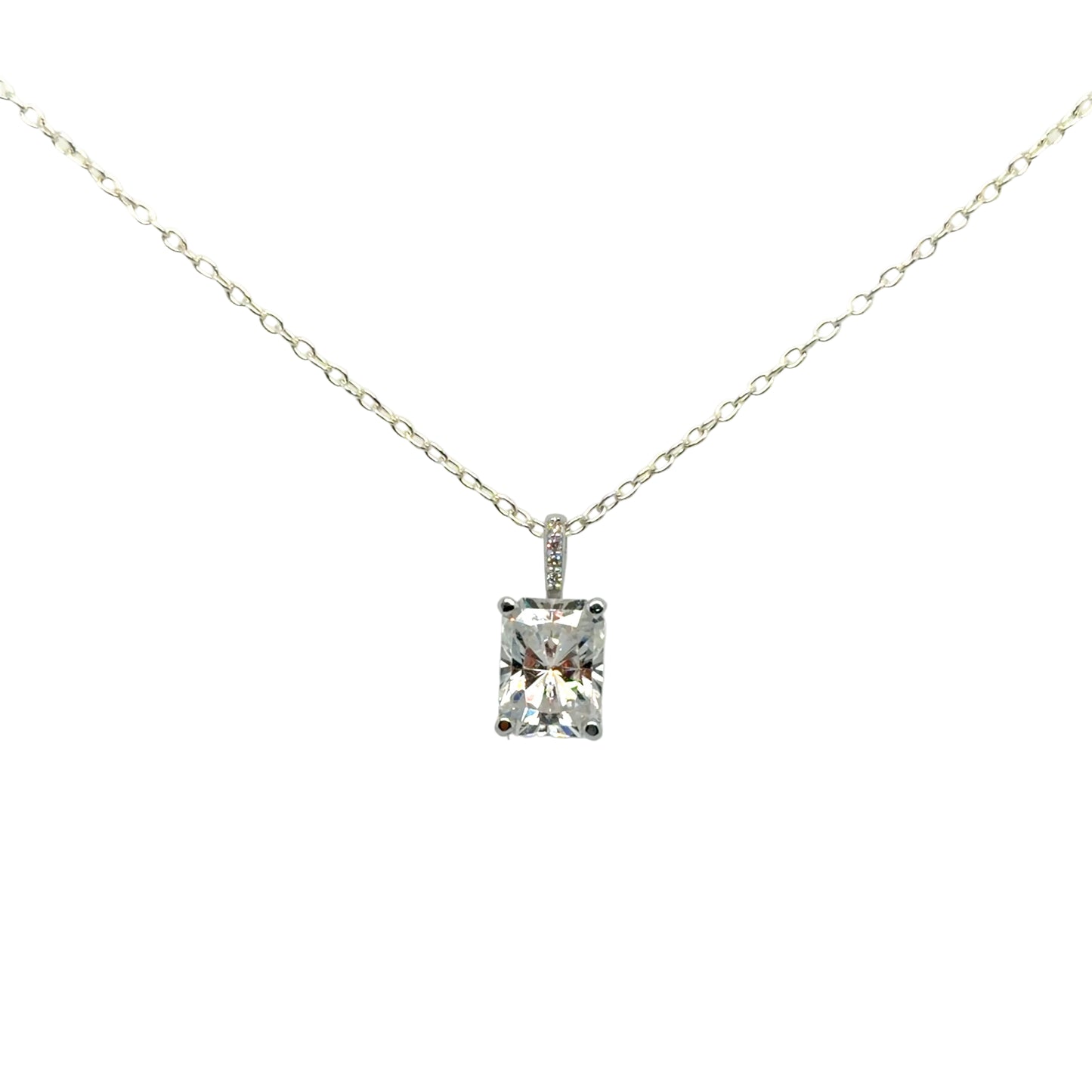 Front view of the 14K white gold solitaire pendant mounting with a radiant-cut moissanite and a diamond-set bail, hanging from a display chain. Chain and center stone are not included.