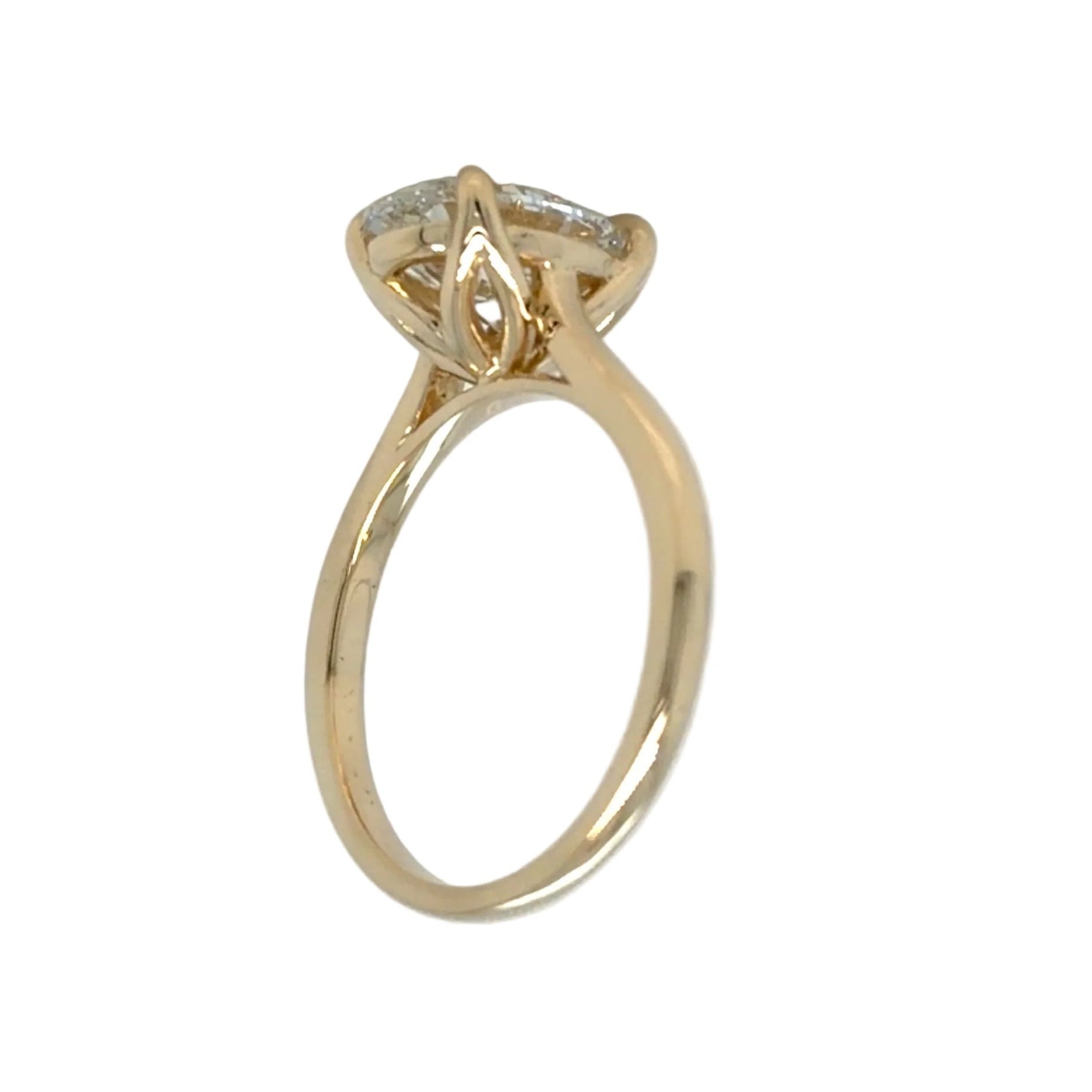 Profile view of the oval tulip solitaire, showing the slim tulip head, the open gallery beneath the diamond and the plain tapered 14K yellow gold shank