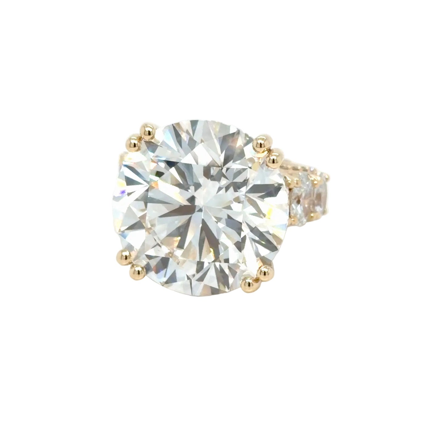 The 24.01 carat round brilliant seen face-up, filling the width of the setting, held by four pairs of yellow gold prongs