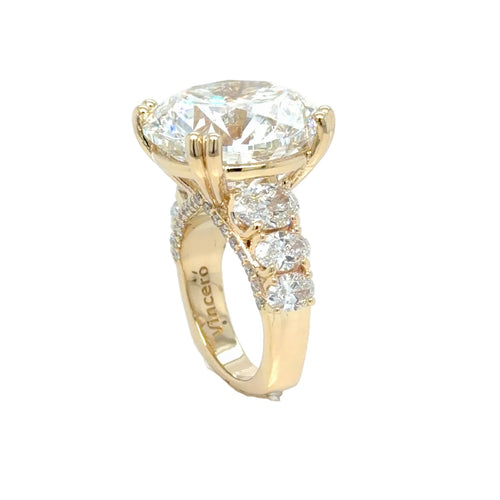 Load image 1 in gallery view. Side profile of the 14K yellow gold ring, the round diamond raised on a split-shoulder head above three graduated oval diamonds running down the shank
