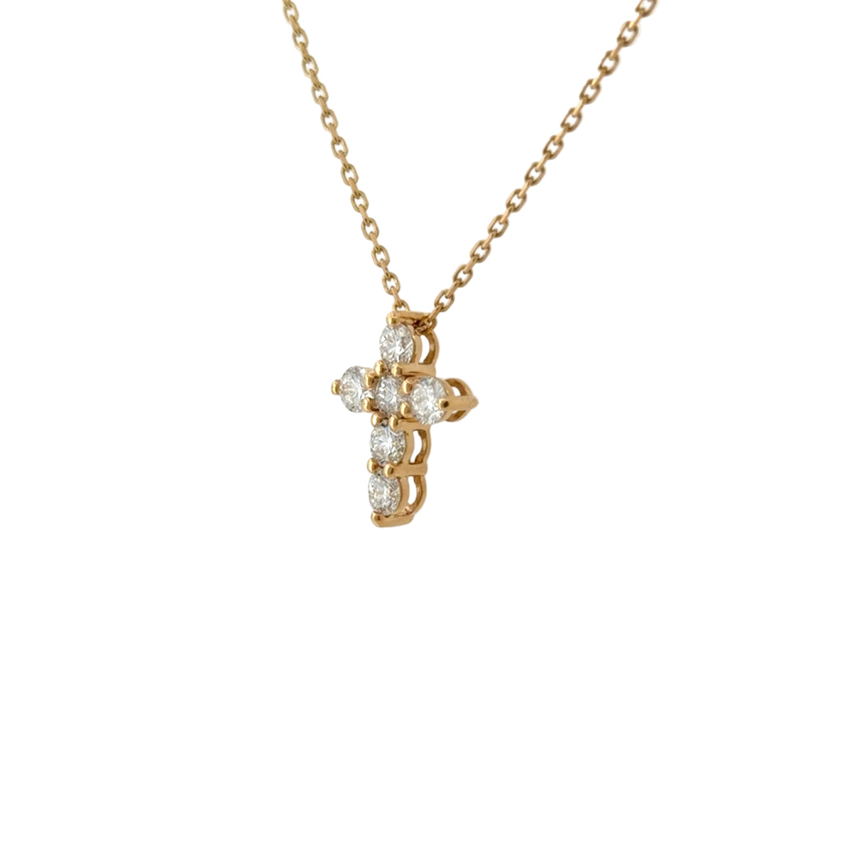 Yellow gold lab-grown diamond cross pendant at an angle, showing the prong settings from the side