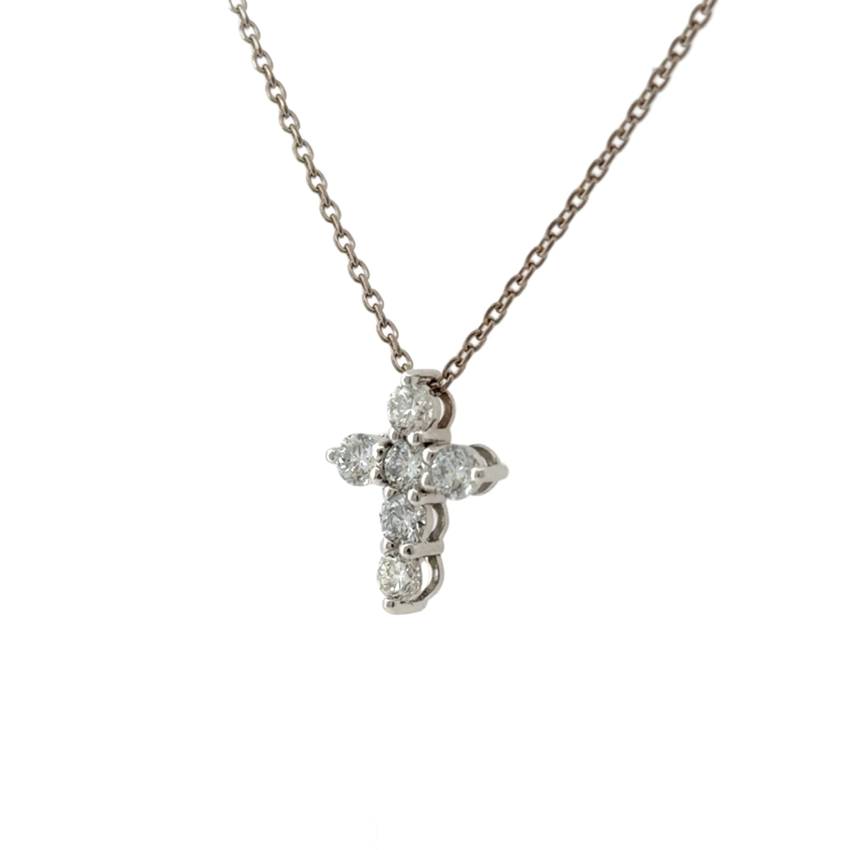 White gold lab-grown diamond cross pendant at an angle, showing the prong settings from the side