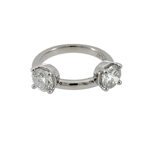 Load image 1 in gallery view. Platinum wrap-style ring enhancer with a round diamond in a four-prong setting on each side of a plain polished band, front view