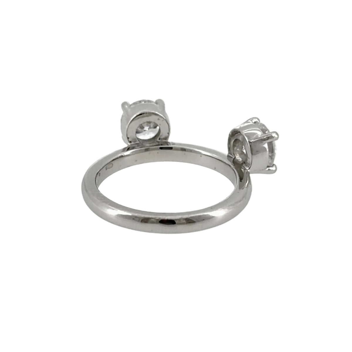 Back view of the platinum ring enhancer showing the polished band and both four-prong diamond settings