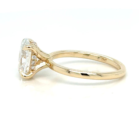 Custom 14K yellow gold oval hidden-halo engagement ring with a lab-grown oval center diamond, made at Farsi Jewelers