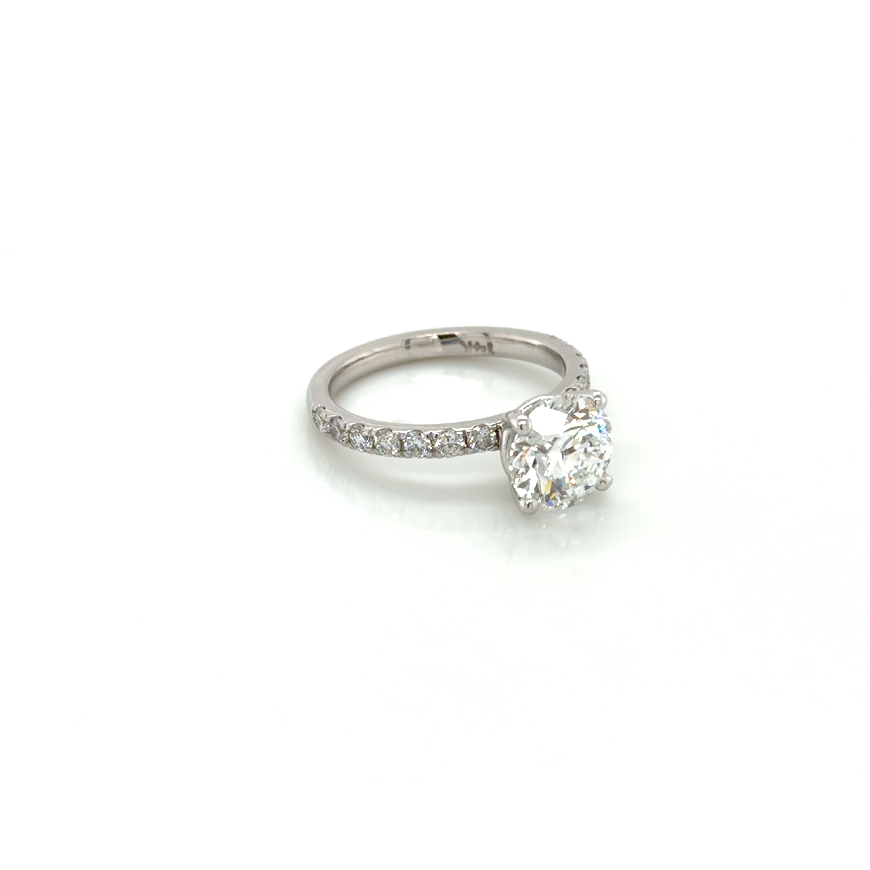 Restored 14K white gold four-prong solitaire engagement ring with a French-set pavé band, rebuilt at Farsi Jewelers in Sandy Springs