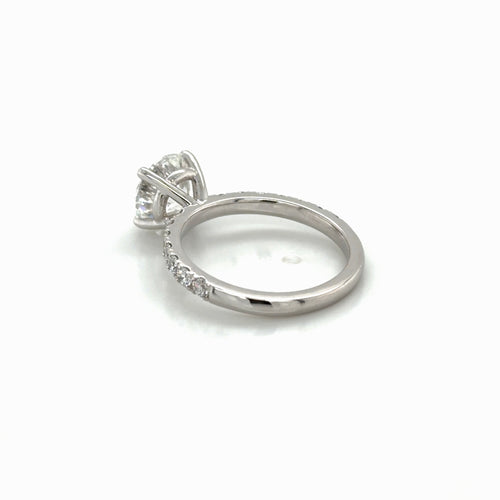 Load image 1 in gallery view. Angled view of the rebuilt 14K white gold four-prong solitaire engagement ring with French-set pavé, Farsi Jewelers