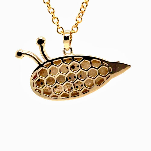 Load image 1 in gallery view. Back of the gold bumblebee pendant showing the pierced honeycomb gallery in 14K yellow gold