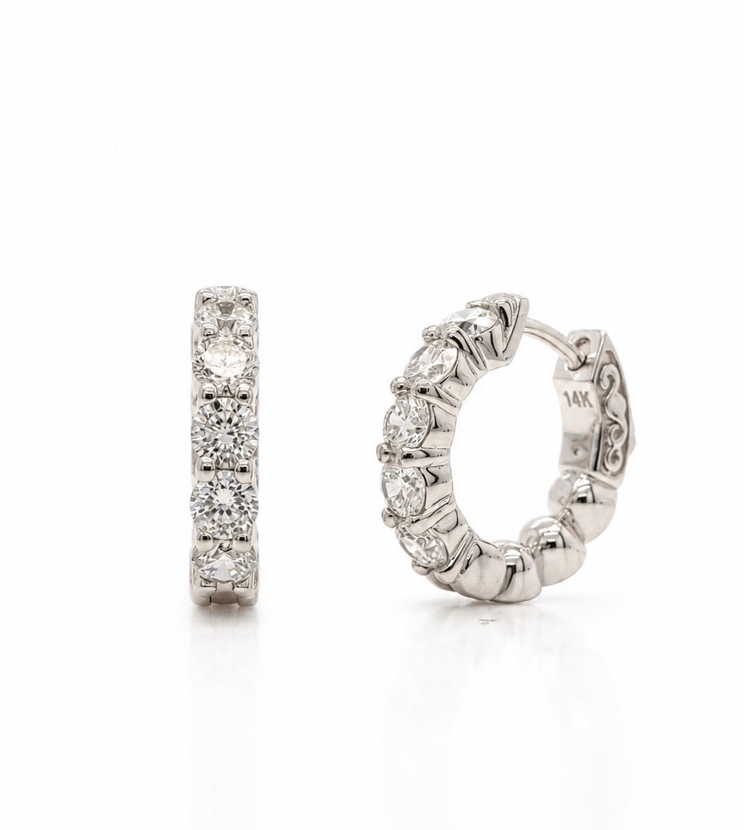14K white gold huggie hoop earrings set with five round lab-grown diamonds each, shown face-on and in profile with the pierced scroll gallery visible