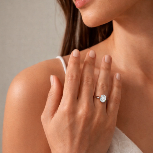 Load image 1 in gallery view. 2.5 carat oval lab-grown diamond cathedral engagement ring in platinum, shown on the hand (3D rendering)