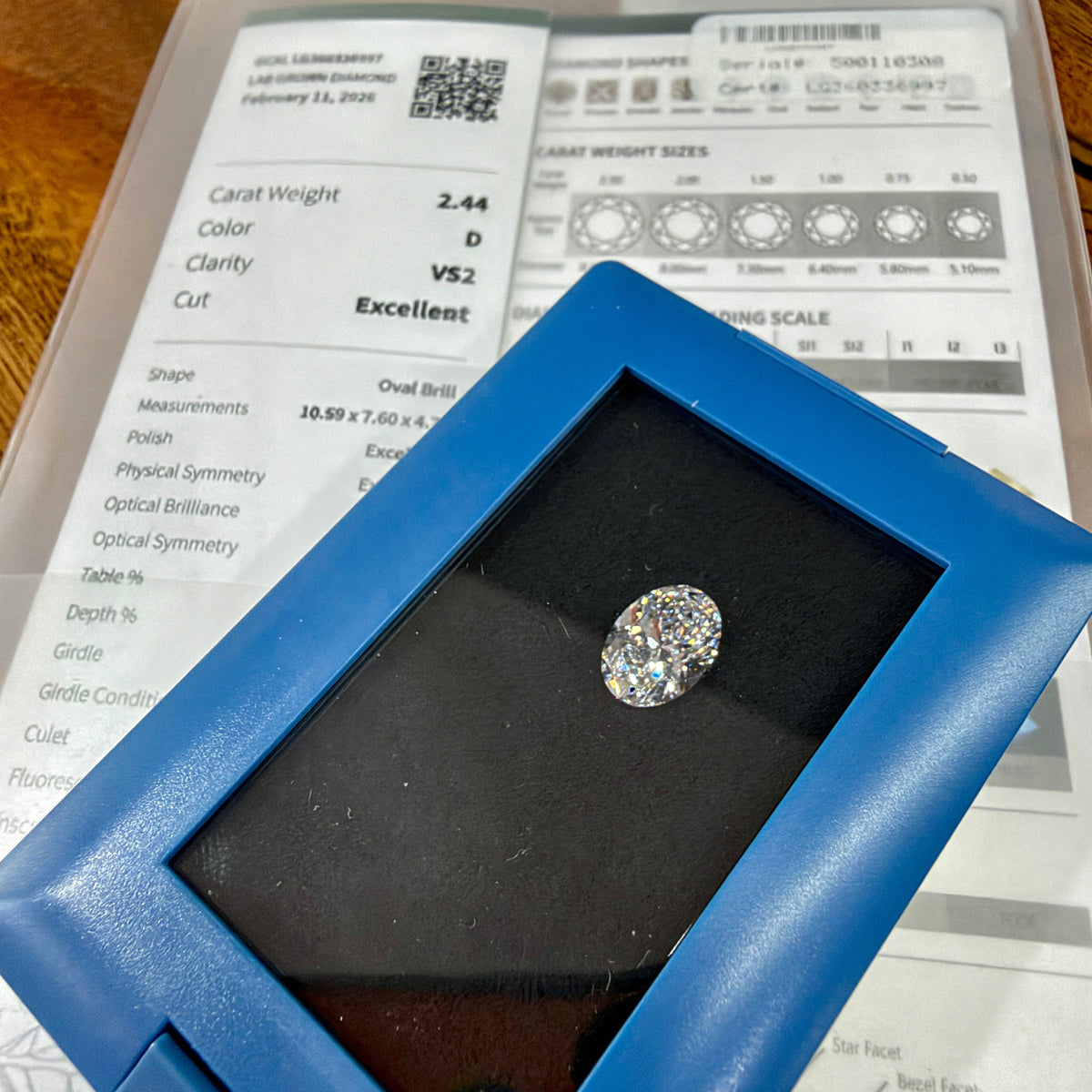 The oval lab-grown diamond for this ring as it arrived at our store, with its GCAL grading report