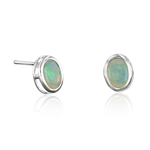 Load image 1 in gallery view. Matched pair of oval opal stud earrings in 14K white gold full bezels, shown face-on and in profile