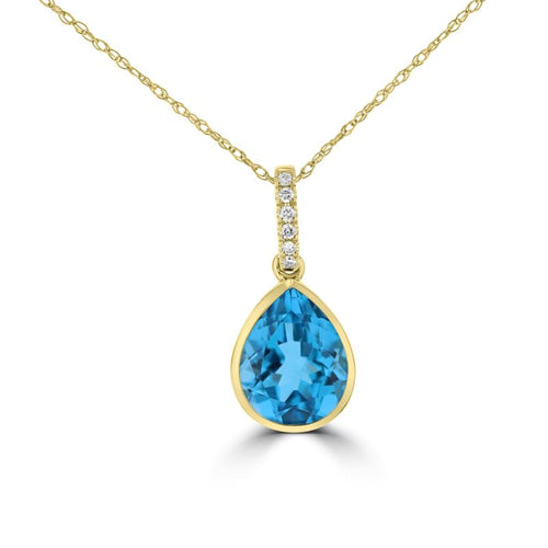 Load image 1 in gallery view. Pear-cut blue topaz in a 14K yellow gold bezel, hung from a bail set with a line of small round diamonds, shown on a chain
