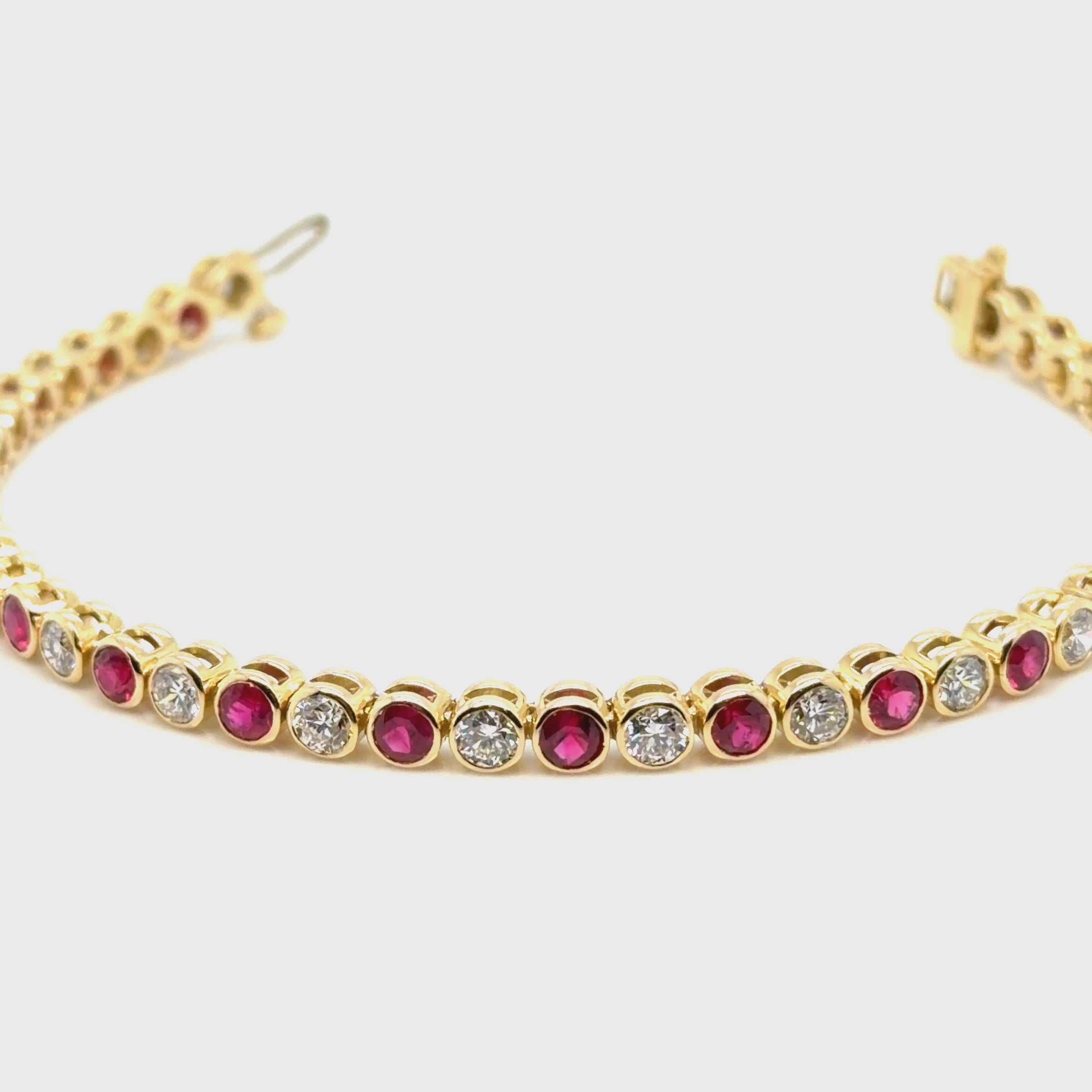 18K Yellow gold diamond and ruby bezel set tennis bracelet. farsi jewelers sandy springs 