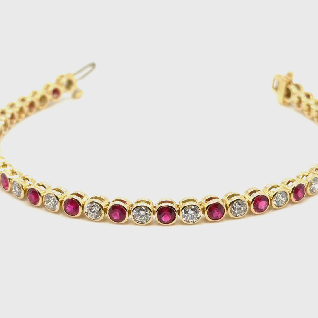 18K Yellow gold diamond and ruby bezel set tennis bracelet. farsi jewelers sandy springs 