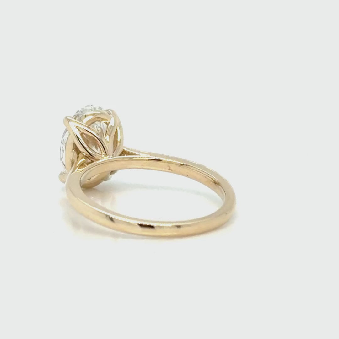 Rotating 360-degree view of the oval tulip solitaire, turning to show the tulip head, the open gallery beneath the 2.24 carat diamond and the plain 14K yellow gold shank