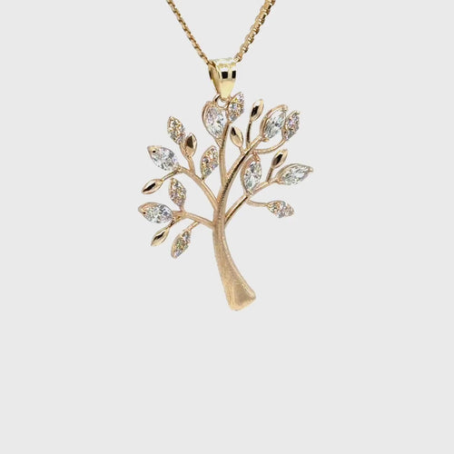 Load image 1 in gallery view. The 14K yellow gold tree of life pendant turning slowly on its chain, catching light across the diamond-set leaves