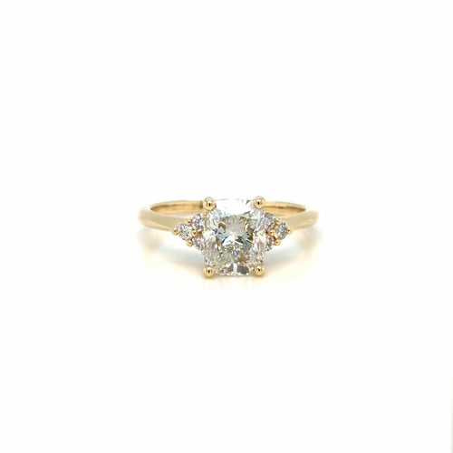 Load image 1 in gallery view. The 14K yellow gold cushion-cut lab-grown diamond engagement ring turning slowly, showing the broad open facets of the center stone and the diamond clusters at each shoulder