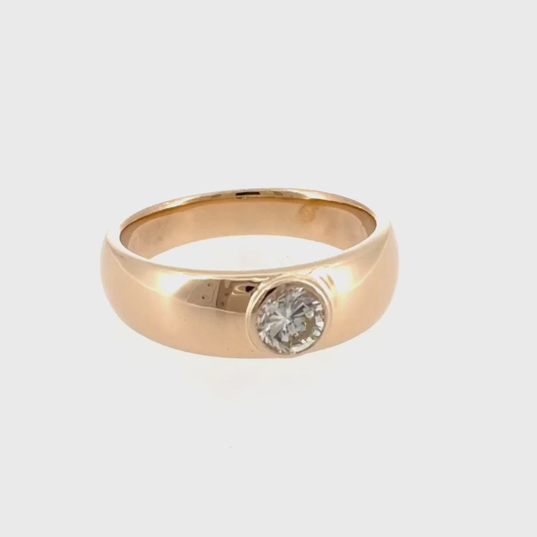 The 14K yellow gold dome ring with its flush-set diamond turning through a full rotation