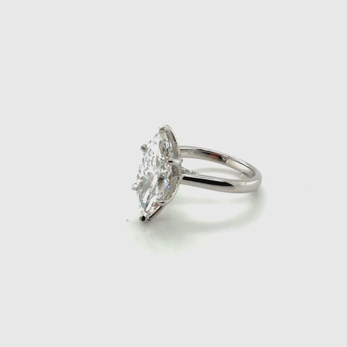 Load image 1 in gallery view. Rotating video of a platinum marquise solitaire engagement ring mounting with tulip prongs and a pavé undergallery, shown with a marquise-shape center stone, at Farsi Jewelers