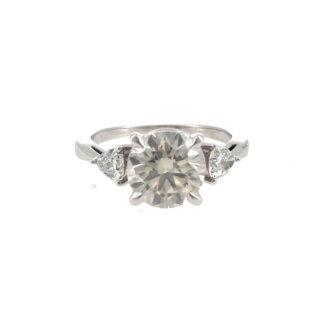 Video of the 14K white gold trillion three-stone engagement ring, shown with a round center stone that is not included
