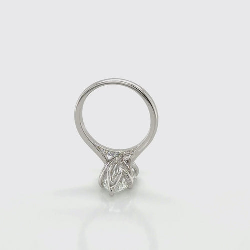Load image 1 in gallery view. Rotating view of a platinum marquise solitaire engagement ring mounting with tulip prongs and a pavé undergallery, shown with a marquise-shape center stone, at Farsi Jewelers