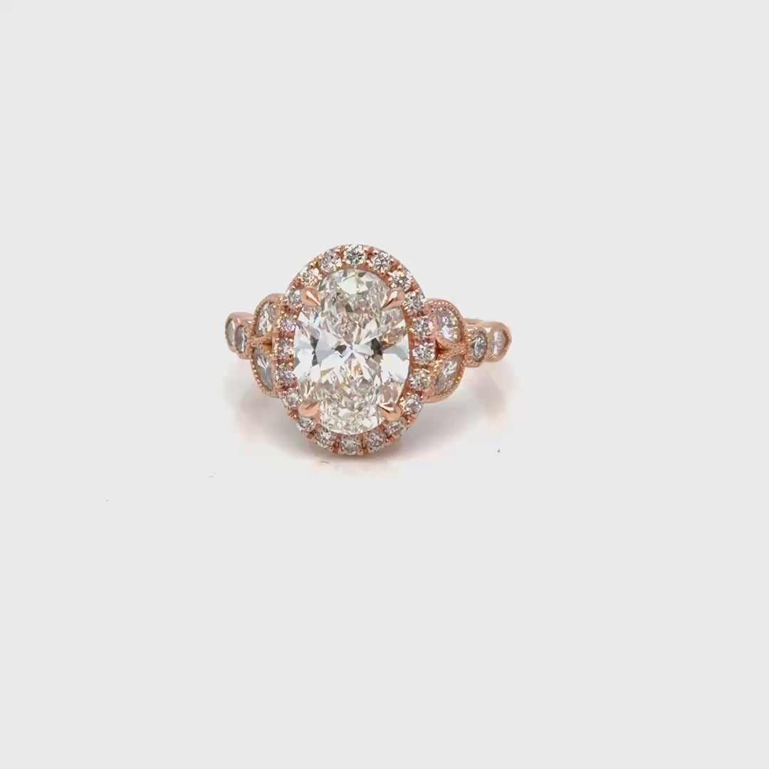 The finished 14K rose gold oval lab-grown diamond halo engagement ring turning to catch the light, Farsi Jewelers