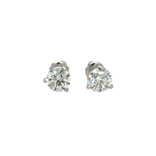 Load image 1 in gallery view. Pair of platinum three-prong martini stud earrings, each set with a round brilliant natural diamond, shown face-on against white