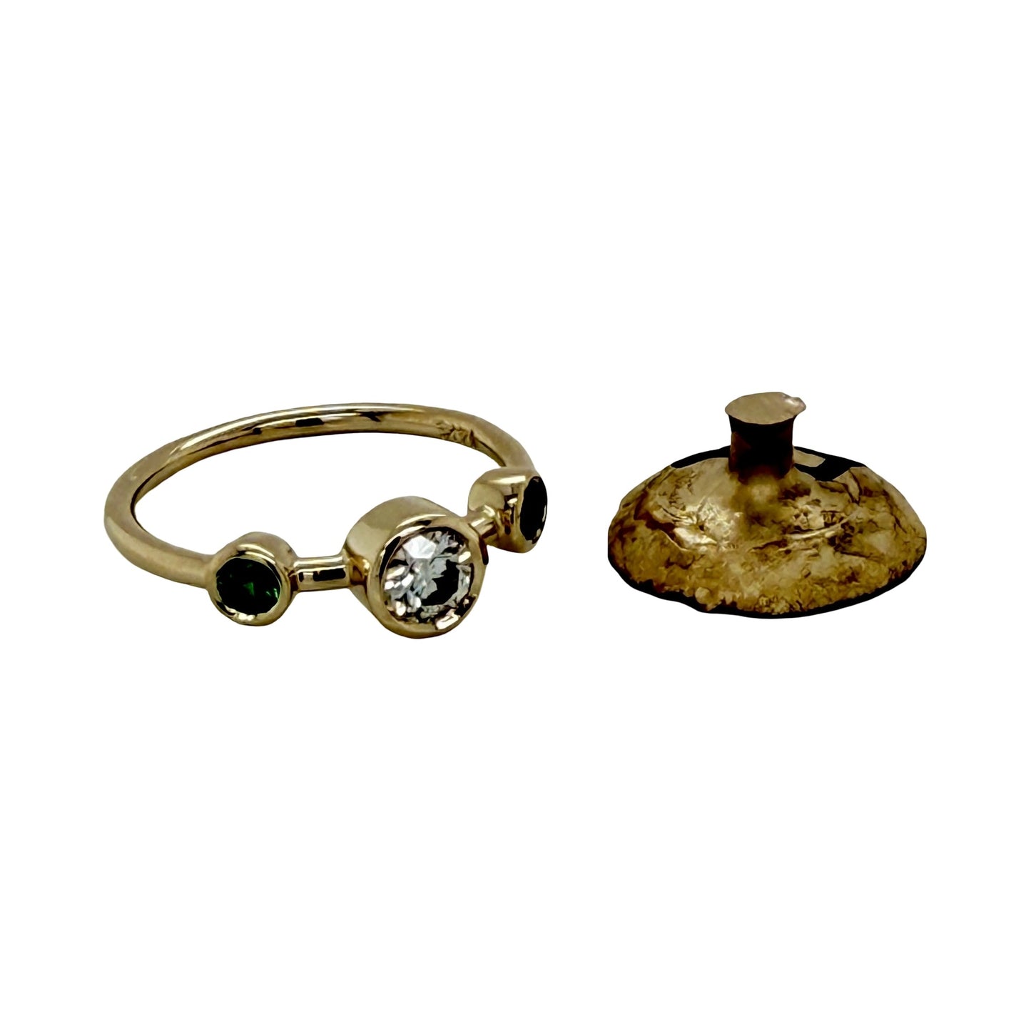 The finished 14K yellow gold three-stone ring beside the leftover casting button of the customer's own gold, the raw metal that remained after the ring was made